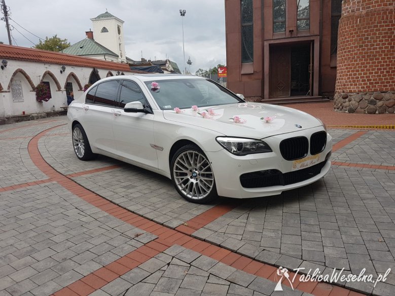 Białe BMW 7 M Pakiet Long na ślub, wesele lub inne imprezy okolicznościowe.